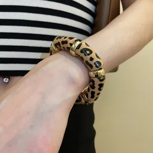 Leopard print acrylic stretch bracelet detail, stylish gold metal beads fashion jewelry.
