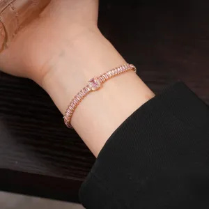 Elegant rose gold tennis bracelet featuring sparkling pink baguette cubic zirconia stones.