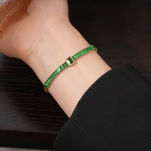 Exquisite green rectangular cubic zirconia bracelet with gold plating, elegant wrist jewelry detail.