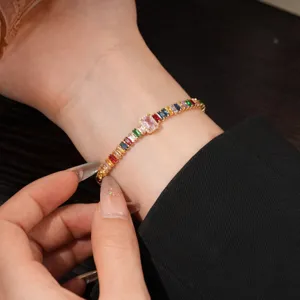 Detailed view of a stunning rainbow baguette cubic zirconia tennis bracelet on wrist.