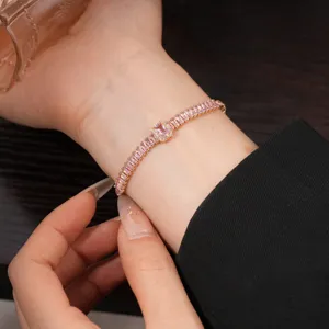 Detailed view of a delicate pink cubic zirconia tennis bracelet worn on wrist elegantly.