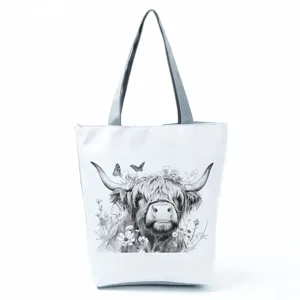 Highland cow print canvas tote bag detail, featuring durable grey straps and secure zipper closure.