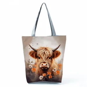 Highland cow print tote bag closeup detail, canvas shoulder bag featuring cute animal design.