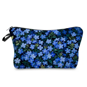 Close-up detail of the blue floral print cosmetic bag showing delicate flower pattern and zipper.