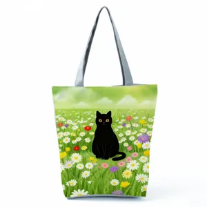 Black cat print canvas tote bag, detailed view of the cute floral pattern and sturdy straps.