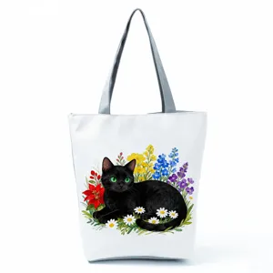 Close-up detail shot of the black cat watercolor print on the white canvas tote bag fabric.