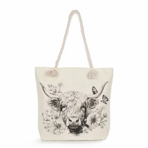 Close-up detail of the black and white Highland cow sketch print on the canvas tote bag.