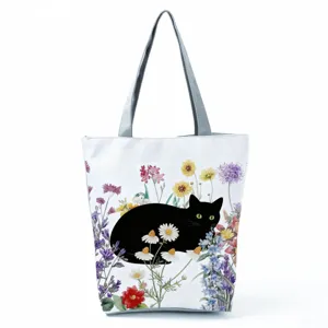 Black cat floral pattern detail on canvas shoulder bag, washable daily shopping tote feature.