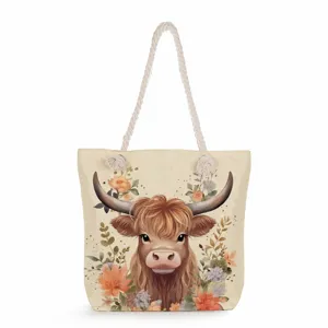 Closeup of the highland cow watercolor print and durable thick rope handle on the canvas tote bag.