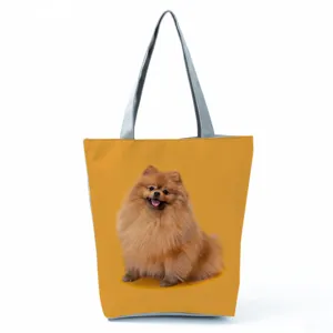 Close-up detail of the cute Pomeranian dog print on the stylish yellow casual canvas tote bag.