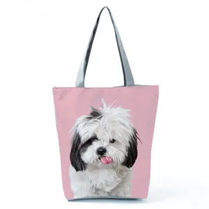 Casual canvas tote bag featuring cute dog print, pink background and grey shoulder straps.