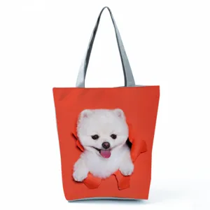 Detailed closeup of the cute white puppy print and orange fabric on the daily tote bag.