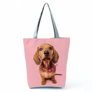 Cute dachshund dog print shoulder tote bag with solid pink background and sturdy grey handles.