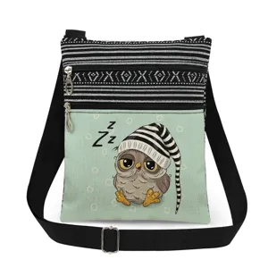 Cute owl print detail on canvas crossbody bag, featuring adjustable strap and dual zippers.