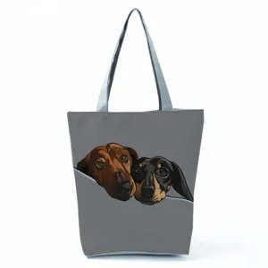 Detailed close-up of the cute dachshund dog print on the stylish grey canvas tote bag.