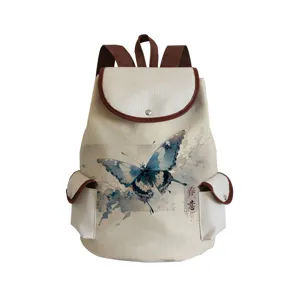 Canvas backpack with blue watercolor butterfly print, stylish school bag with brown leather trim.