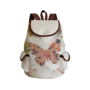 Close-up view of canvas backpack featuring floral butterfly print and brown leather trim details.