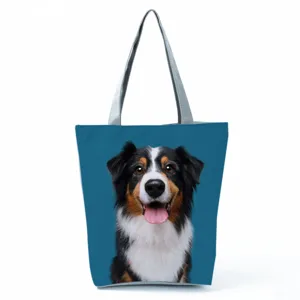 Close-up detail of the adorable dog graphic print canvas tote bag with durable sturdy handles.