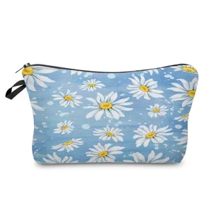 Detailed view of the blue daisy floral print cosmetic bag showing fabric texture and zipper.