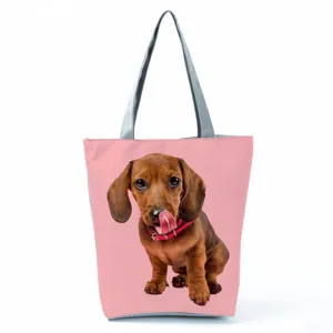 Dachshund dog print detail view on pink tote bag with stylish grey shoulder straps.