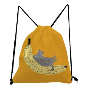 Detailed view of the cute grey cat resting on banana print on the yellow drawstring bag.