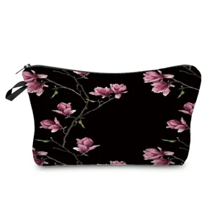 Floral print cosmetic bag detail view, black and pink makeup pouch for travel and storage.