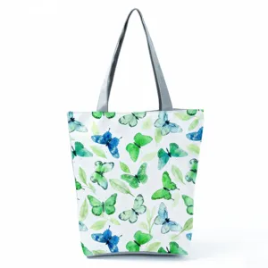 Detailed view of a fashionable women's shoulder tote bag featuring a watercolor butterfly print.