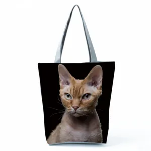 Closeup detail of the large capacity black tote bag featuring a realistic cat print and grey straps.