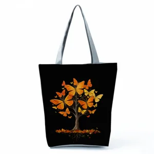 Black canvas tote bag with butterfly tree print, large capacity casual shoulder bag for women.
