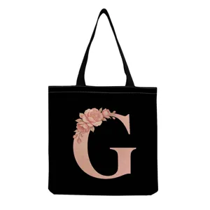 Sac cabas en toile noire avec imprimé lettre G florale rose, sac fourre-tout réutilisable.
