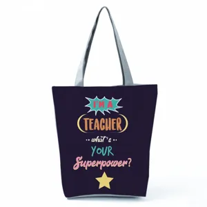Teacher quote printed graphic detail on black canvas tote bag for daily office use.
