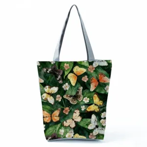 Close-up detail of watercolor butterfly print fabric tote bag with elegant green leaf design.