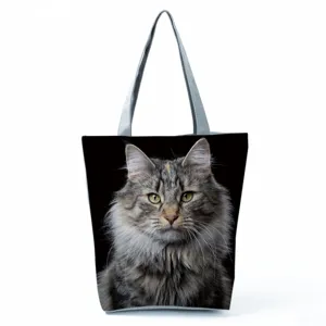 Detailed view of the cat print tote bag fabric, featuring a realistic feline portrait and sturdy gray straps.