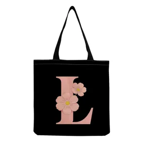 Sac cabas en toile noire avec une charmante impression de lettre L florale rose.