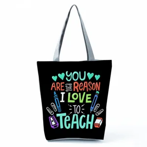 Teacher tote bag detail, black canvas shoulder bag with lovely education typography print.