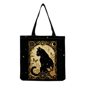 Close-up detail of the mystical black cat tote bag showing intricate gold print and handles.