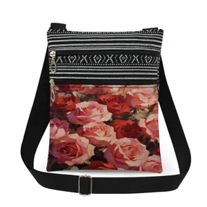 Detailed view of the double zipper crossbody bag with vintage rose floral print details.