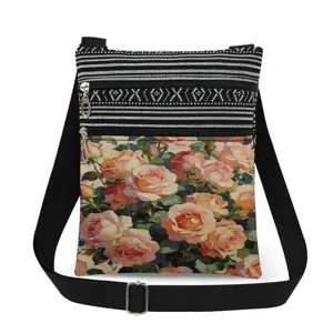 Detail shot of vintage rose print crossbody bag with black white striped pattern and double zippers.