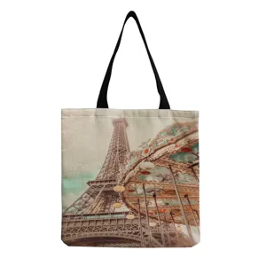 Detailed view of the canvas tote bag featuring a vintage Eiffel Tower and carousel print.
