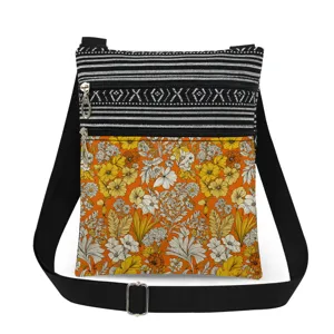 Floral print crossbody bag with double zippers and adjustable strap for daily use.