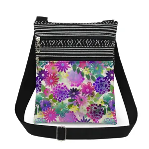 Colorful floral print crossbody bag with double zippers and adjustable black strap.