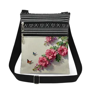 Detailed view of lightweight canvas crossbody messenger bag with floral print and black strap.