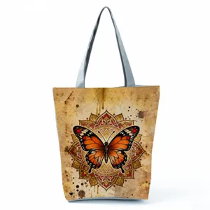 Close-up detail of the vintage butterfly print tote bag showing fine mandala pattern and texture.