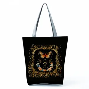 Elegant black canvas tote bag featuring a stunning golden butterfly and floral print design.
