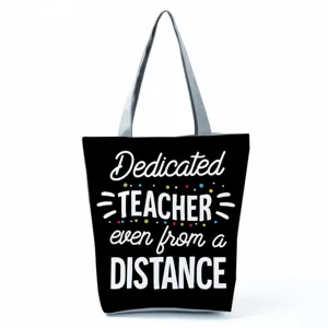 Close-up detail of teacher appreciation tote bag with printed text, canvas shoulder bag view.