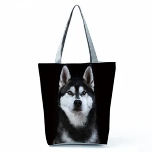 Close-up detail of the vivid Siberian Husky dog print design on this black tote bag.