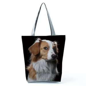 Detailed view of a large canvas tote bag featuring a cute dog print and shoulder straps.