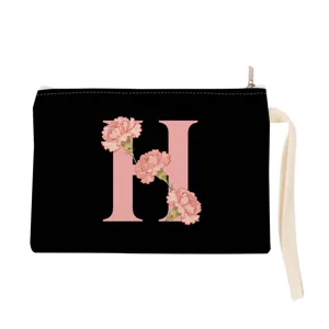 Black canvas zipper pouch with pink initial letter H and floral design, wrist strap.