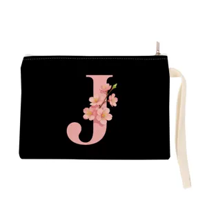 Black canvas cosmetic pouch featuring a pink floral letter J design with wrist strap.