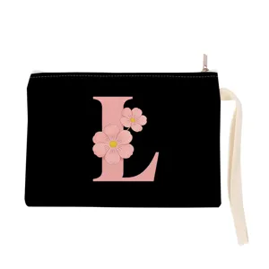 Detail view of black canvas pouch with pink floral letter L print, zipper and wrist strap.